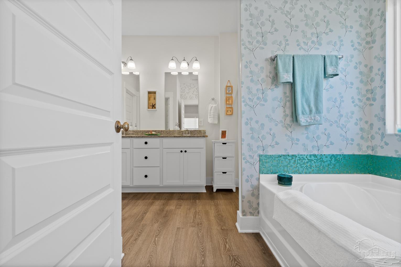 5773 Danbury Boulevard Pace, FL 32571 - Photo 16 of 34 a bathroom with a bathtub a sink and a mirror