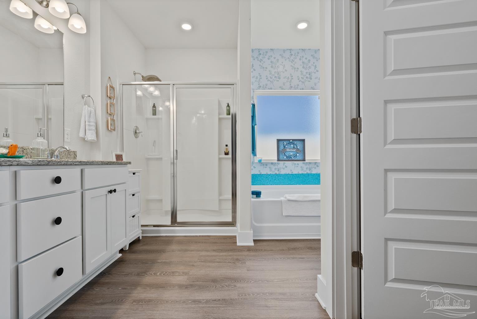 5773 Danbury Boulevard Pace, FL 32571 - Photo 19 of 34 a bathroom with a sink a mirror and a shower