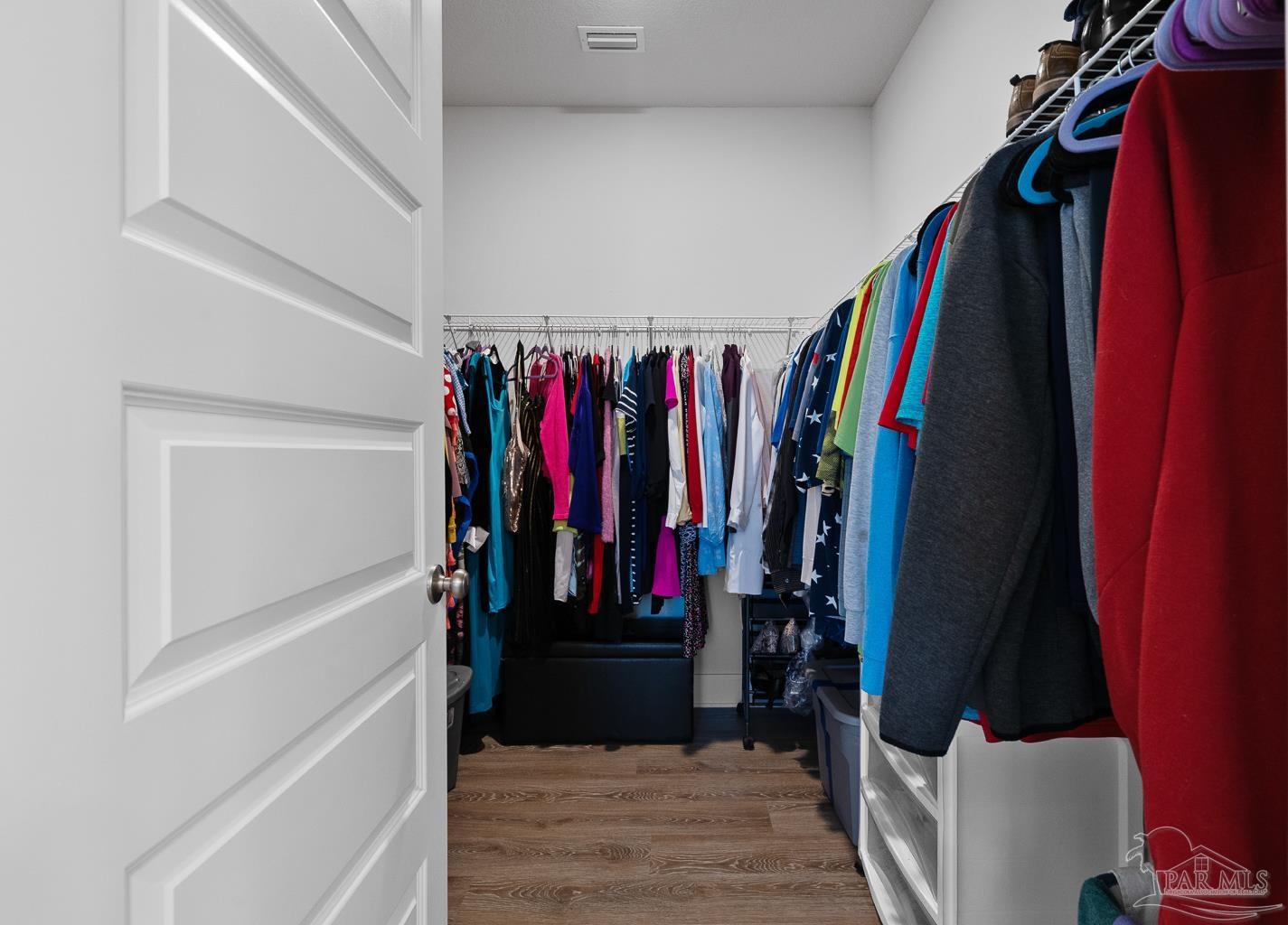 5773 Danbury Boulevard Pace, FL 32571 - Photo 20 of 34 a view of walk in closet with clothes