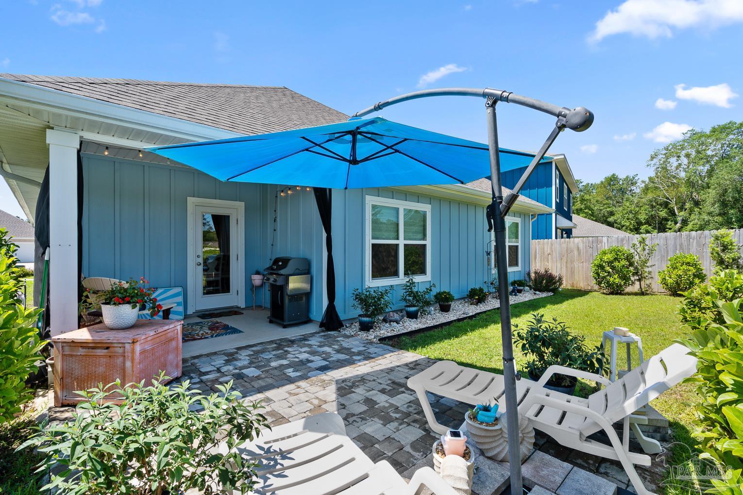5773 Danbury Boulevard Pace, FL 32571 - Photo 29 of 34 a view of a house with backyard sitting area and garden