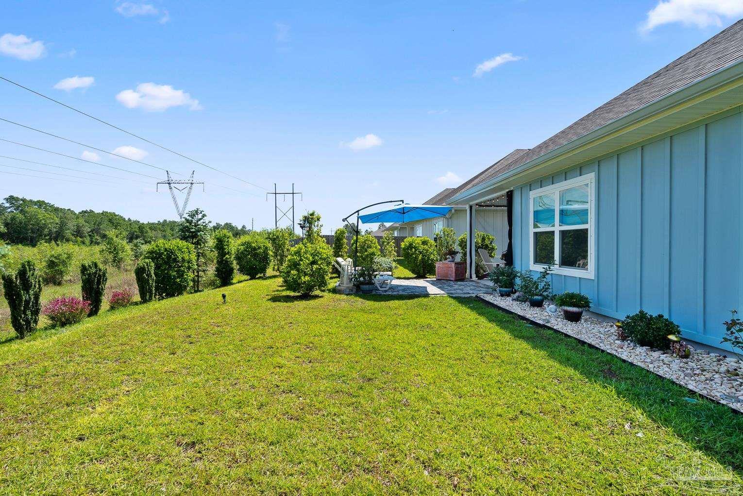 5773 Danbury Boulevard Pace, FL 32571 - Photo 34 of 34 a view of a backyard with plants and a garden