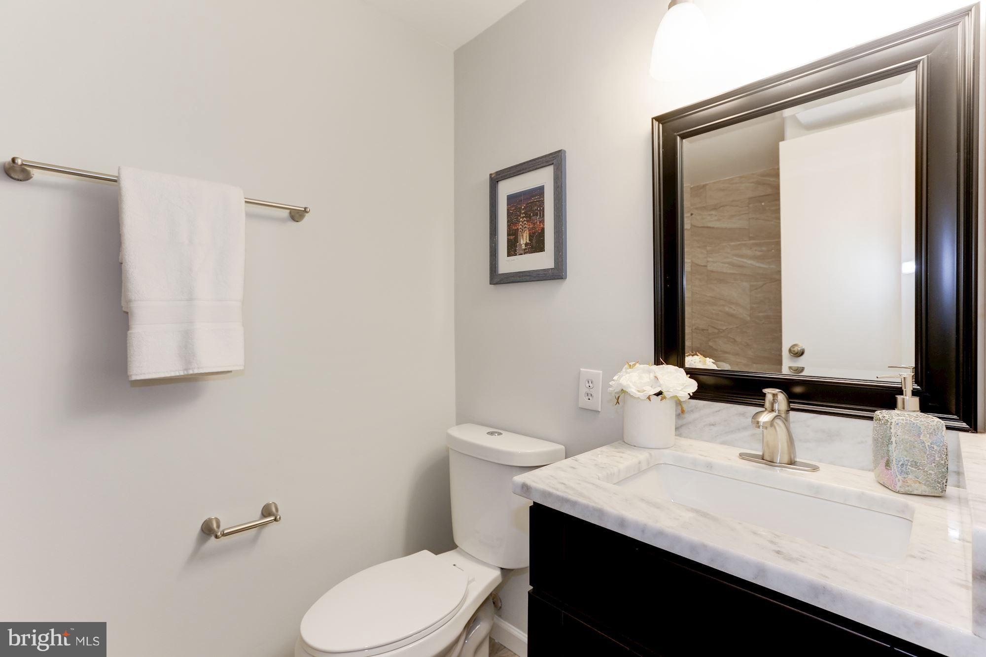 11570 Embers Court Reston, VA 20191 - Photo 24 of 30 a bathroom with a granite countertop sink toilet and mirror