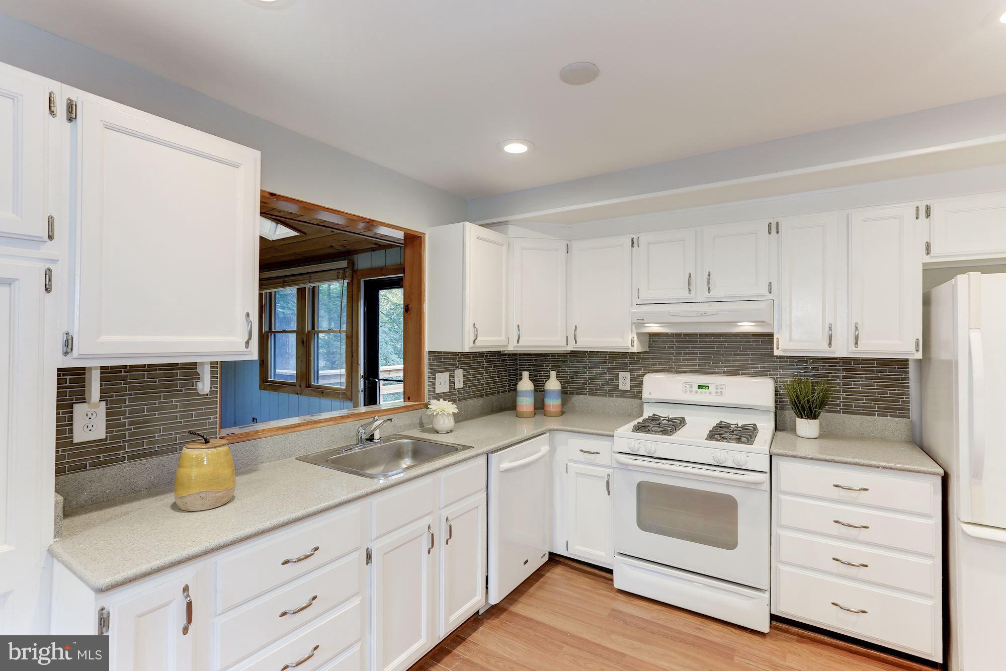 11570 Embers Court Reston, VA 20191 - Photo 5 of 30 a kitchen with granite countertop white cabinets white stainless steel appliances and sink