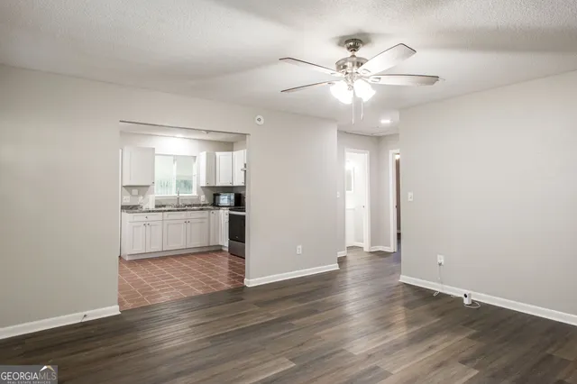 a kitchen with stainless steel appliances granite countertop a refrigerator a sink a stove a microwave and island