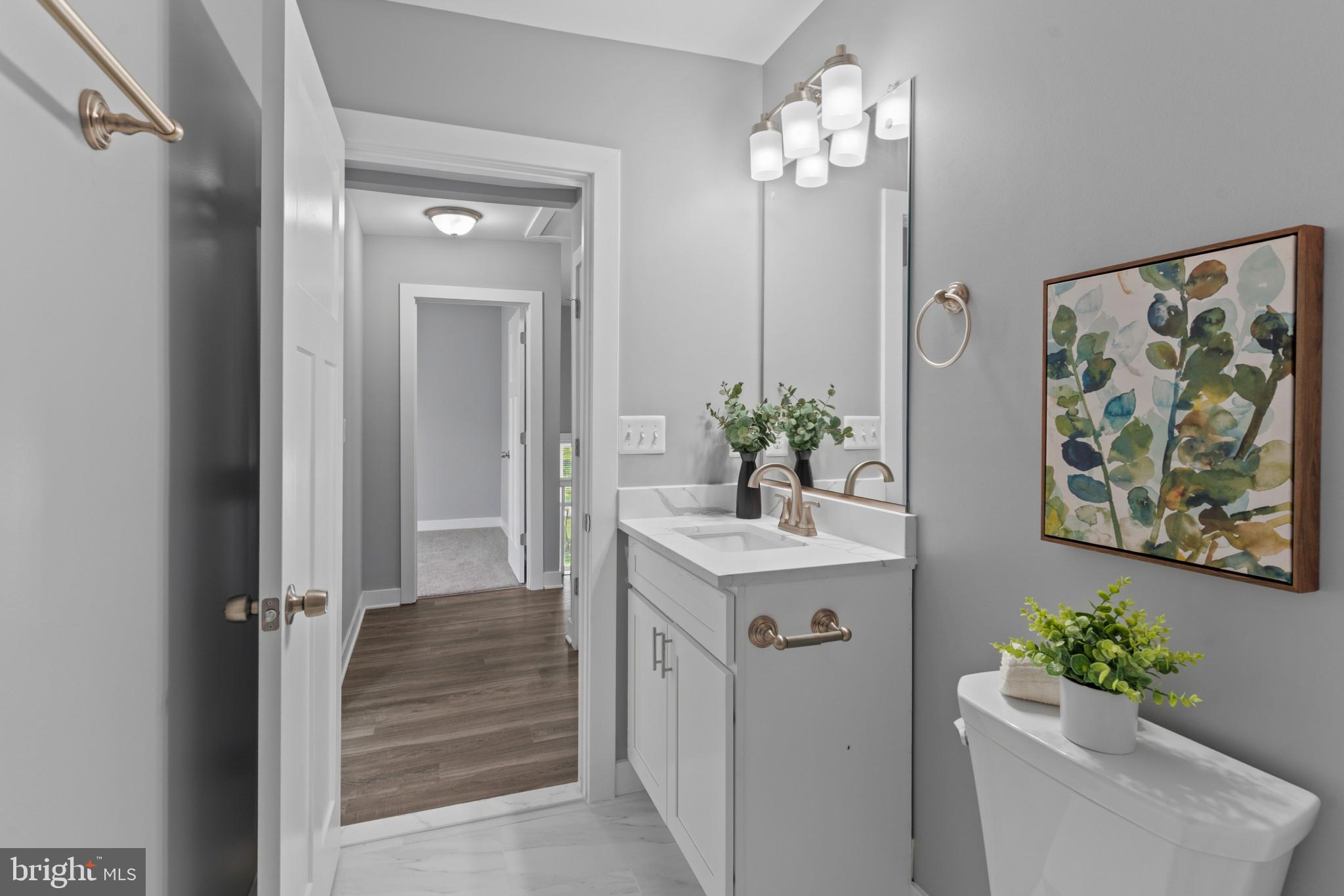 5728 Clover Road Baltimore, MD 21215 - Photo 29 of 40 a bathroom with a sink mirror and vanity