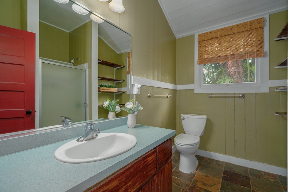48-5263 Kukuihaele Road Honokaa, HI 96727 - Photo 12 of 30 a bathroom with a granite countertop toilet a sink and a mirror
