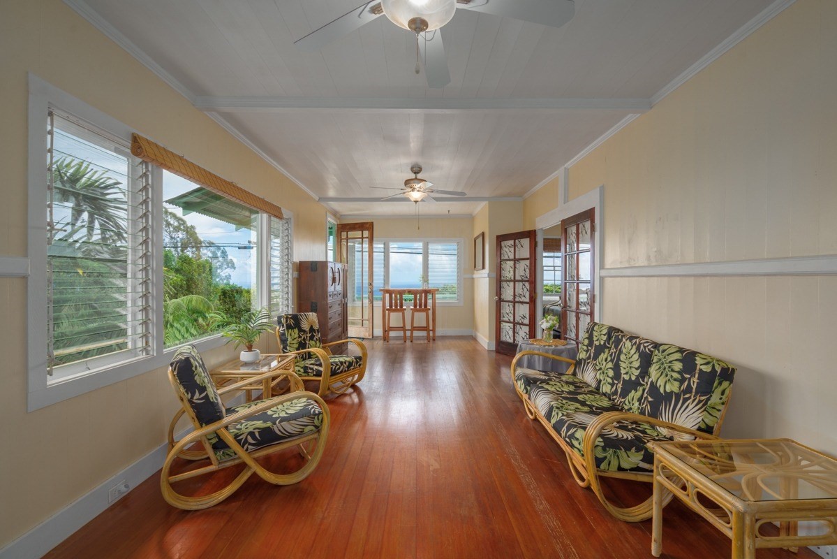 48-5263 Kukuihaele Road Honokaa, HI 96727 - Photo 3 of 30 a living room with furniture a ceiling fan and a large window
