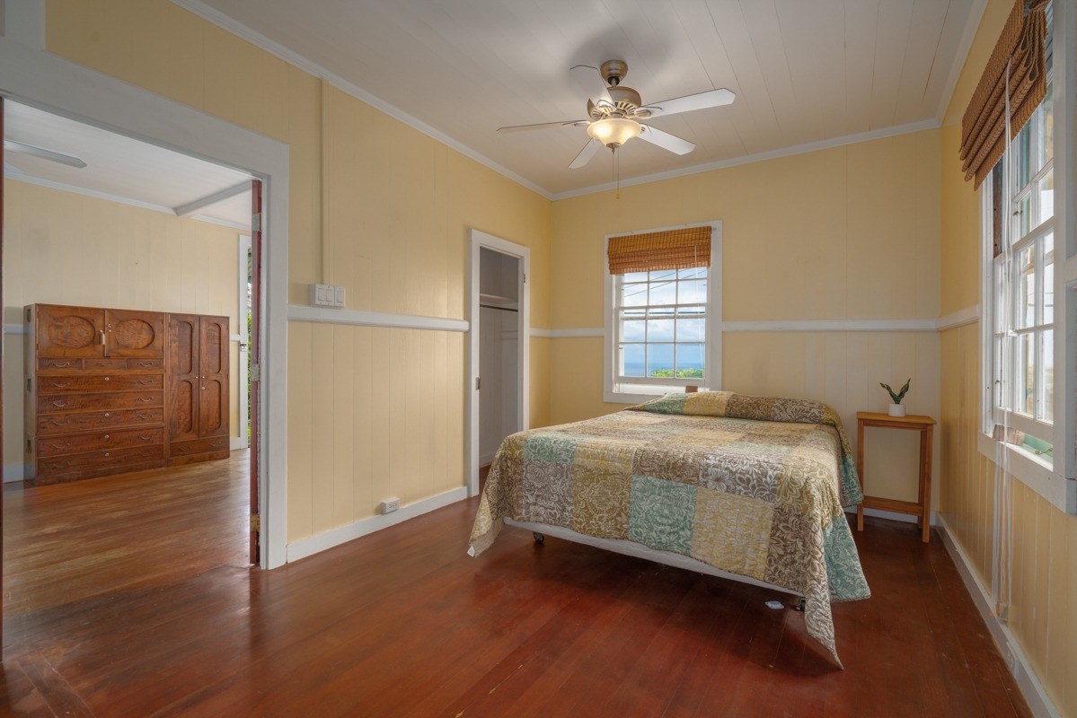 48-5263 Kukuihaele Road Honokaa, HI 96727 - Photo 8 of 30 a bedroom with a bed and a chandelier