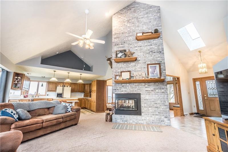 108 Castile Ridge Road Waynesburg, PA 15370 - Photo 8 of 25 WOW... inside is just as great as the outdoor space... Your open floor plan has a stunning living room with vaulted ceilings and a wrap-around wood burning fireplace.