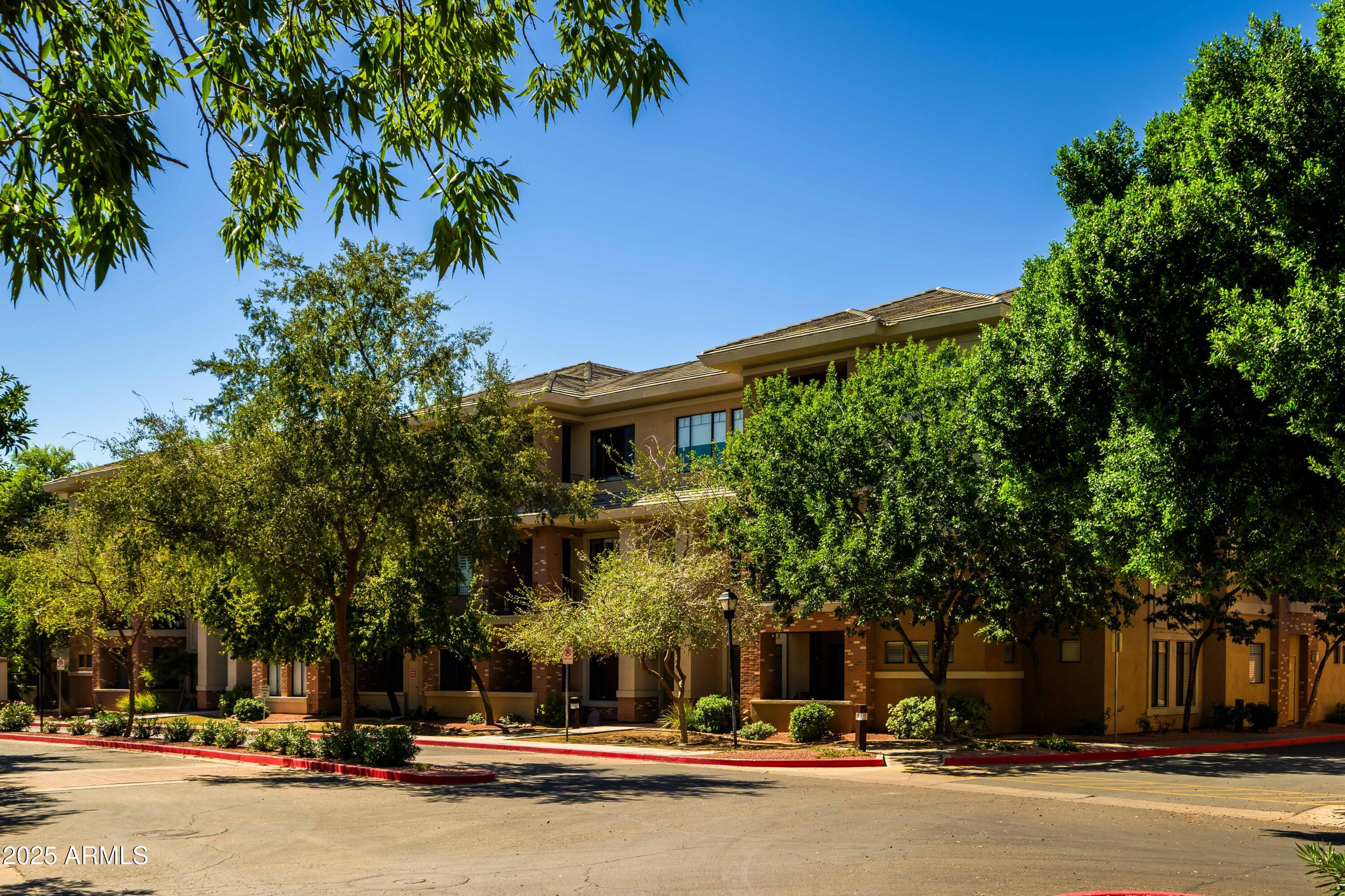 2989 North 44th Street, Unit 2001 Phoenix, AZ 85018 - Photo 20 of 30 a couple of cars parked in front of a building