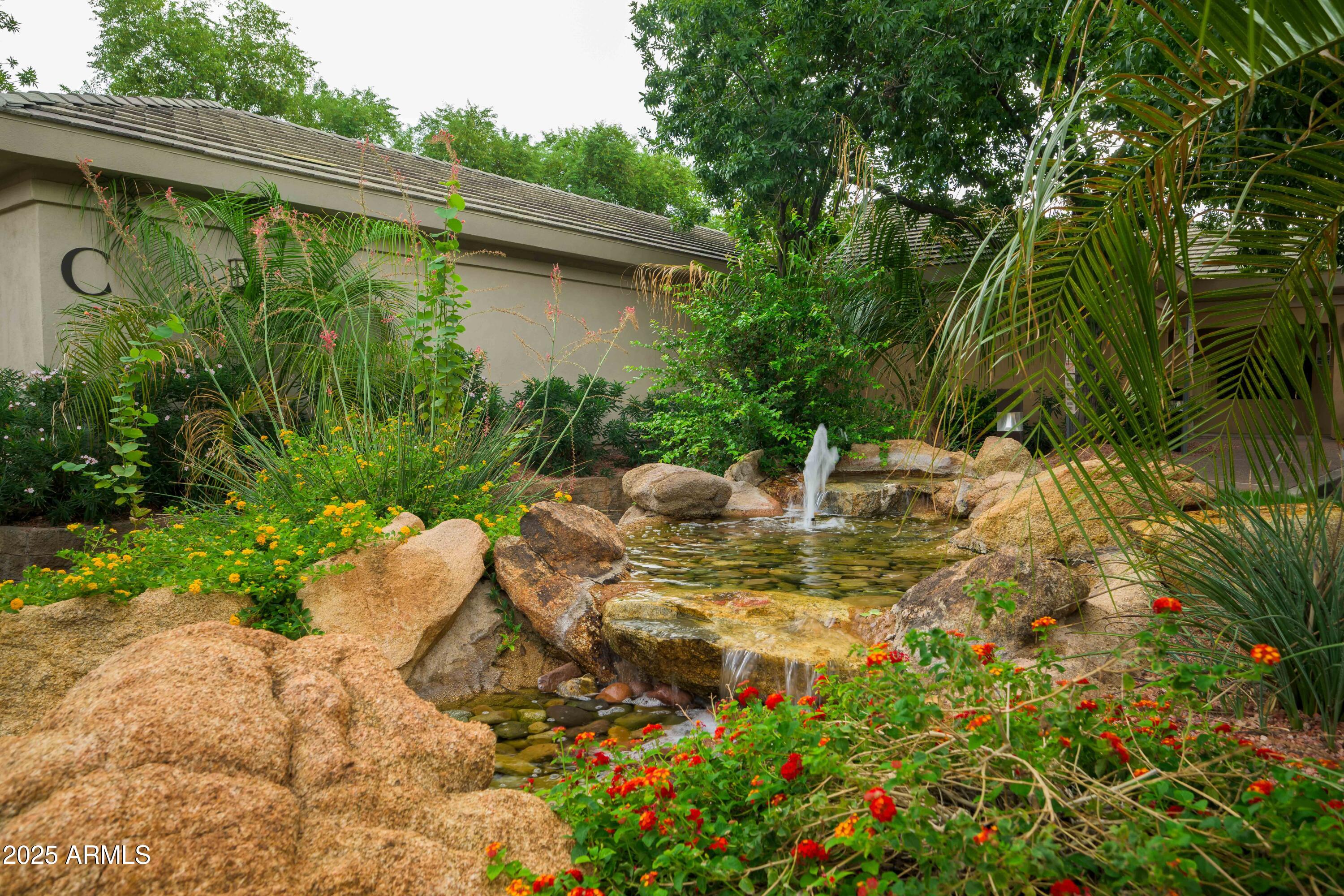 2989 North 44th Street, Unit 2001 Phoenix, AZ 85018 - Photo 24 of 30 a view of a chair and table in the garden
