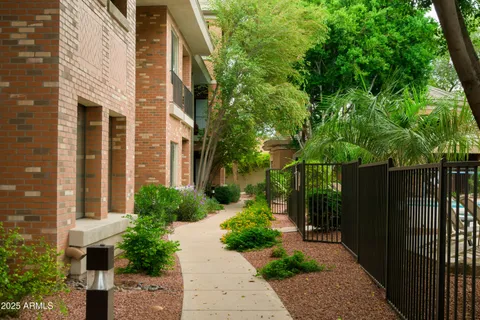 a view of a pathway with a house and a yard