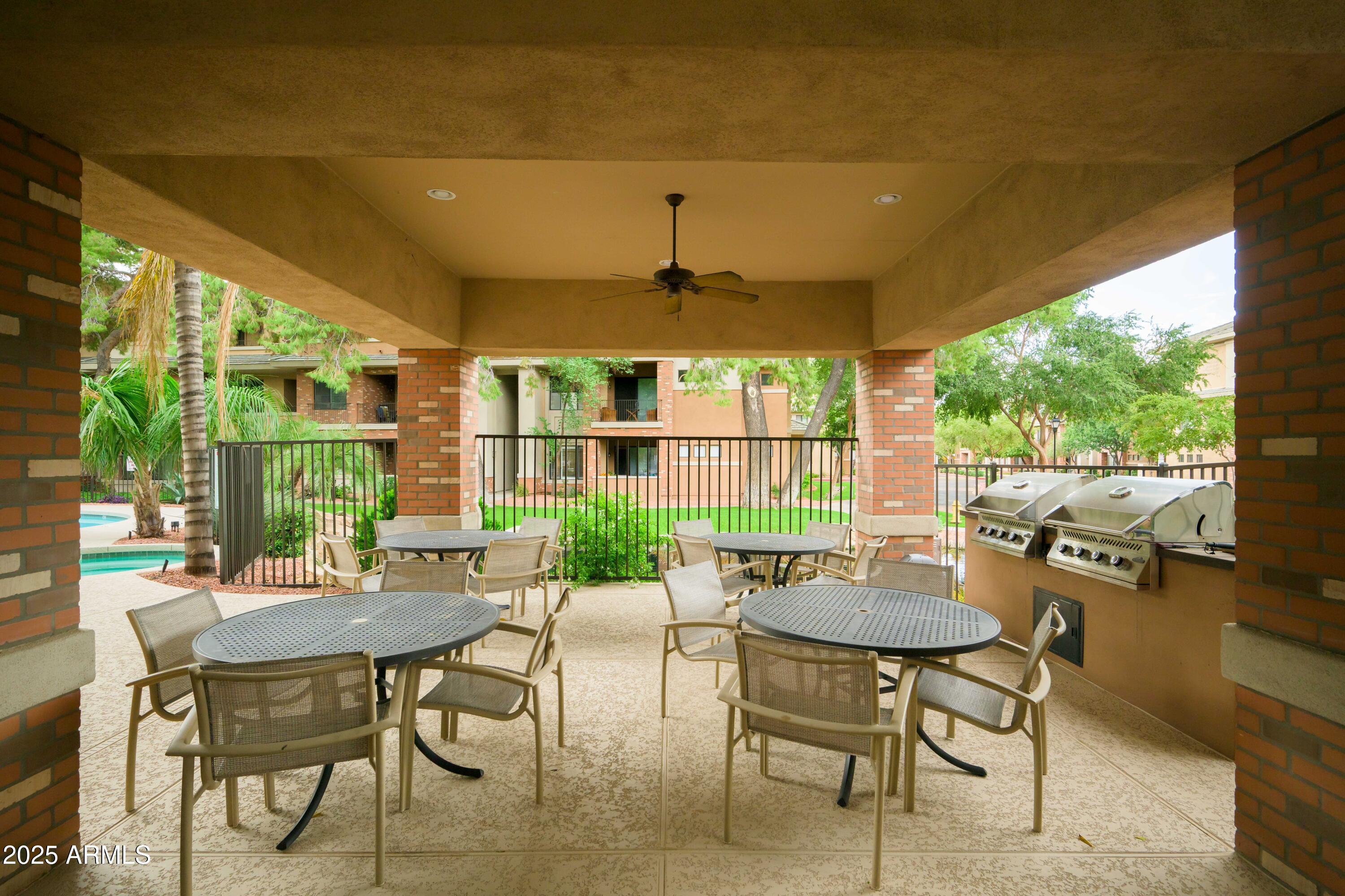 2989 North 44th Street, Unit 2001 Phoenix, AZ 85018 - Photo 27 of 30 a view of a patio with a dining table and chairs