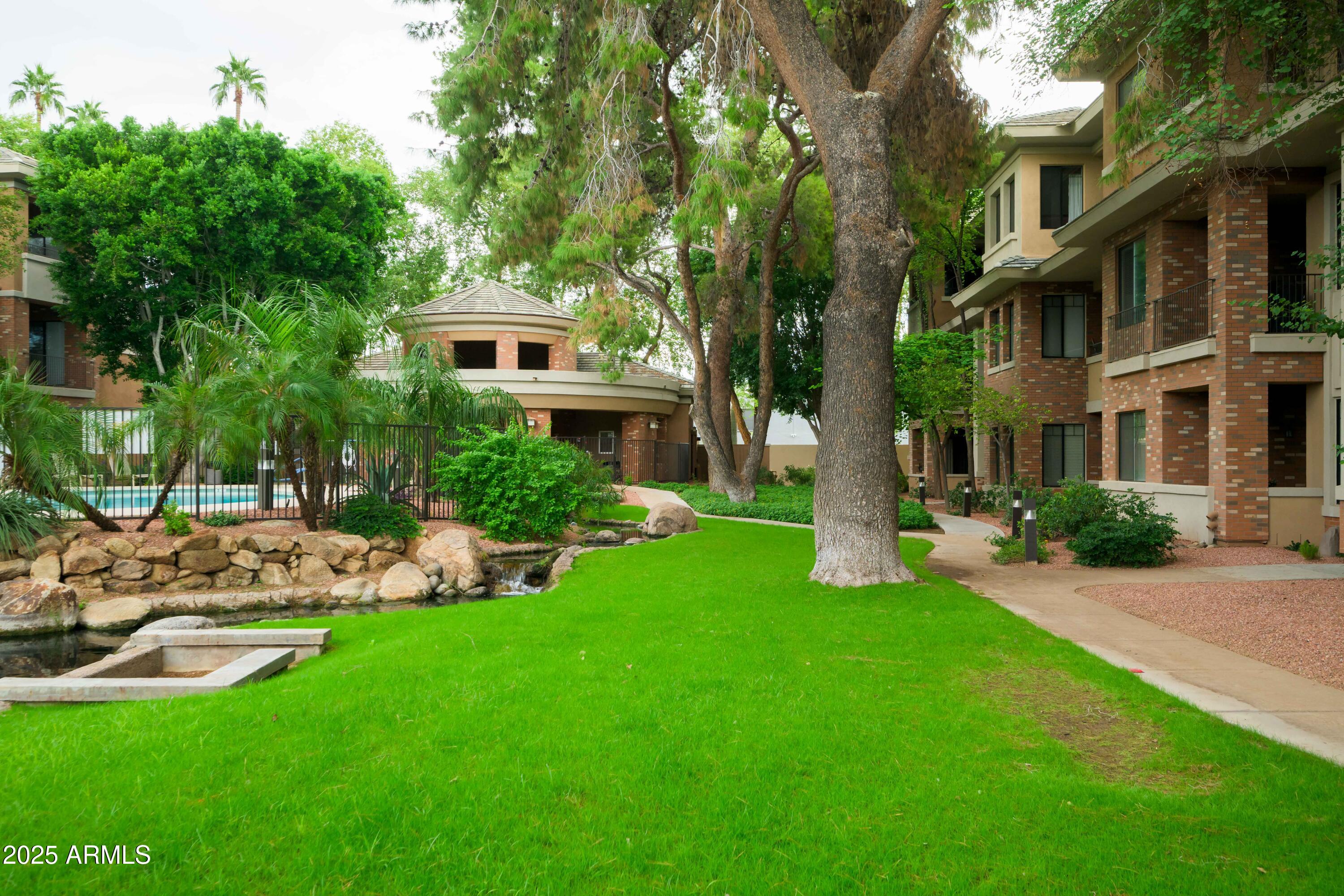 2989 North 44th Street, Unit 2001 Phoenix, AZ 85018 - Photo 28 of 30 a front view of a house with a yard table and chairs