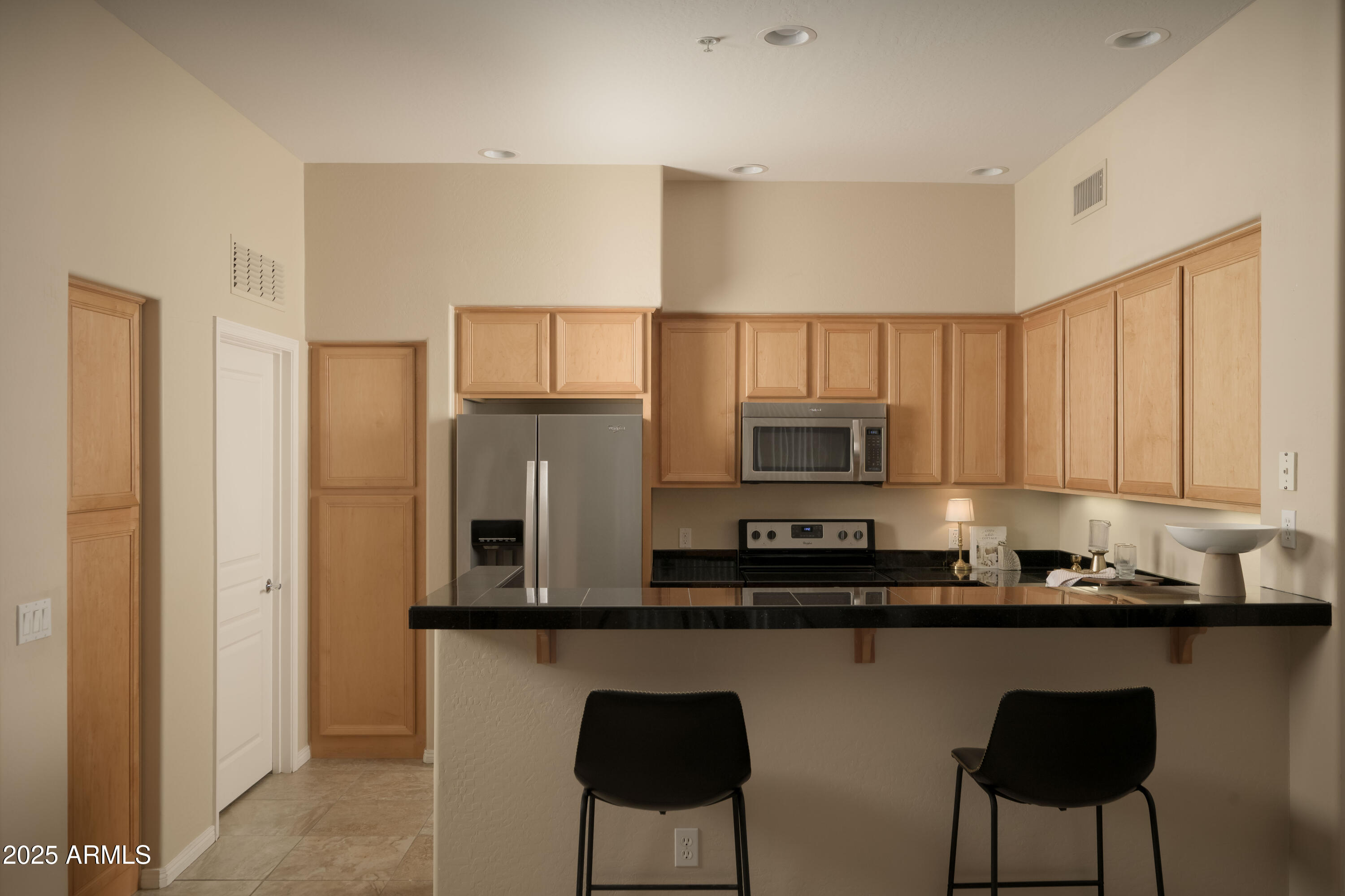 2989 North 44th Street, Unit 2001 Phoenix, AZ 85018 - Photo 3 of 30 a kitchen with stainless steel appliances granite countertop a refrigerator and microwave