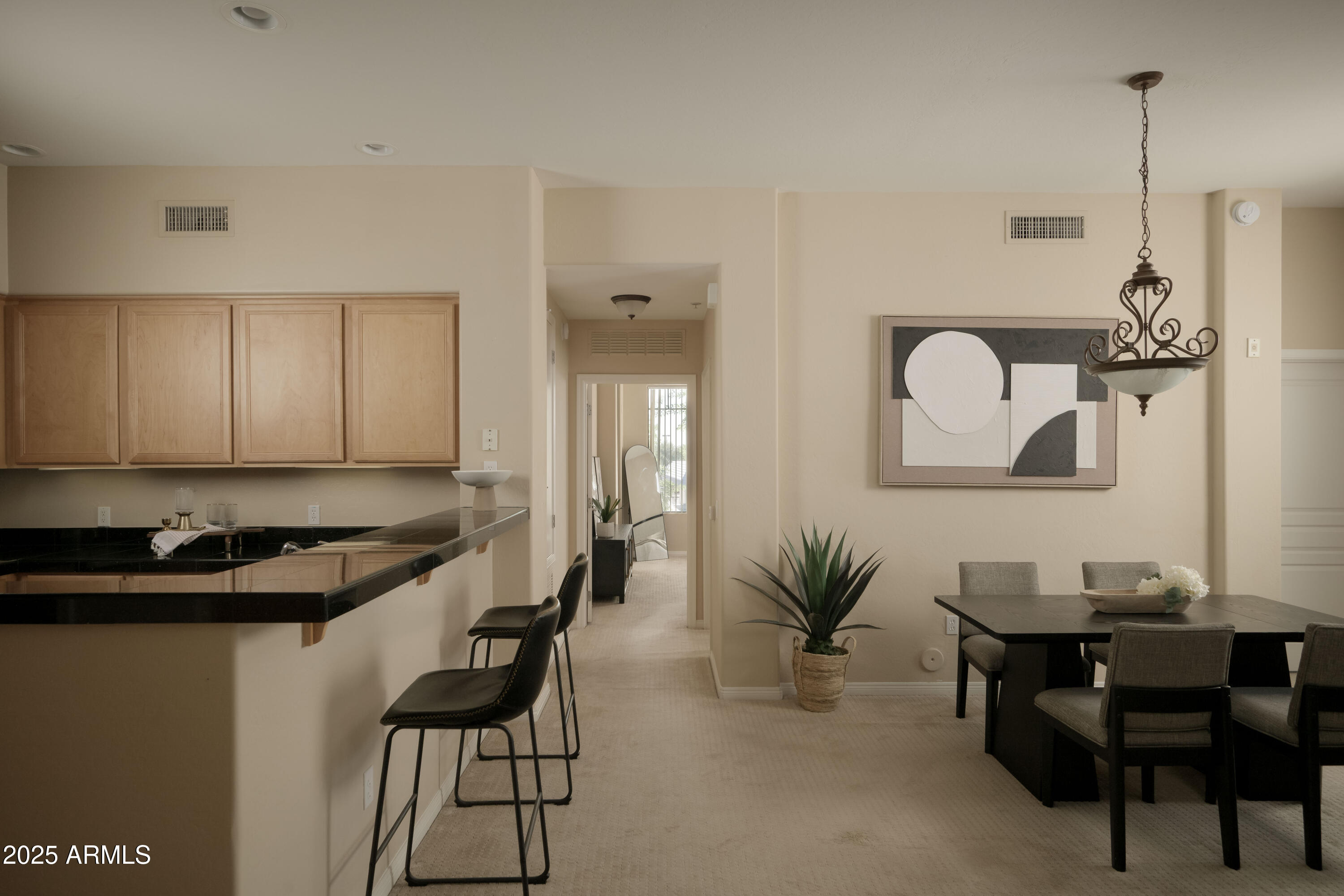 2989 North 44th Street, Unit 2001 Phoenix, AZ 85018 - Photo 5 of 30 a kitchen with a table and chairs in it