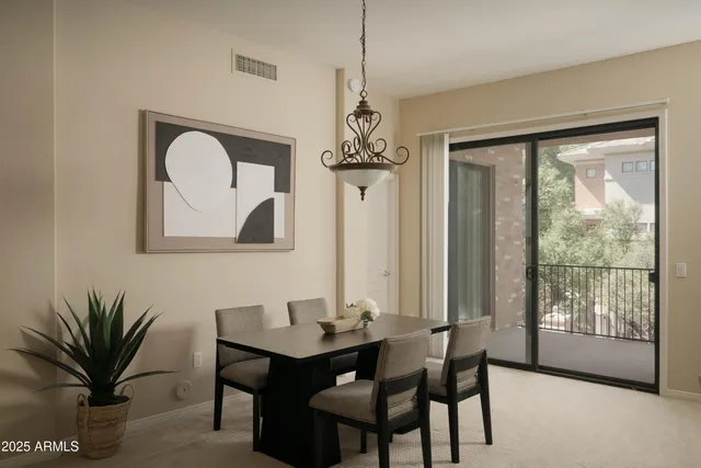 a dining room with furniture and window