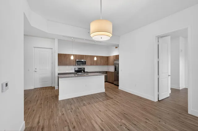 a view of a patio with a table and chairs under an umbrella