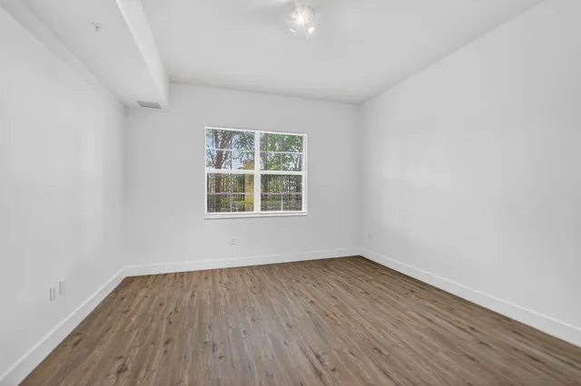 a view of a house with entertaining space and trees