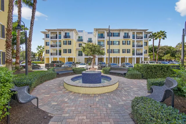a kitchen with granite countertop a refrigerator and wooden cabinets