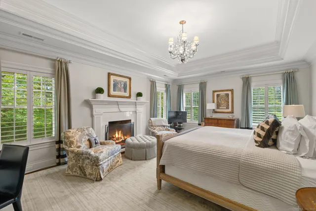 a bedroom with a bed and a fireplace