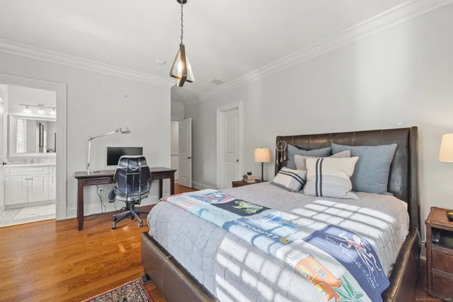 a bedroom with bed and a table