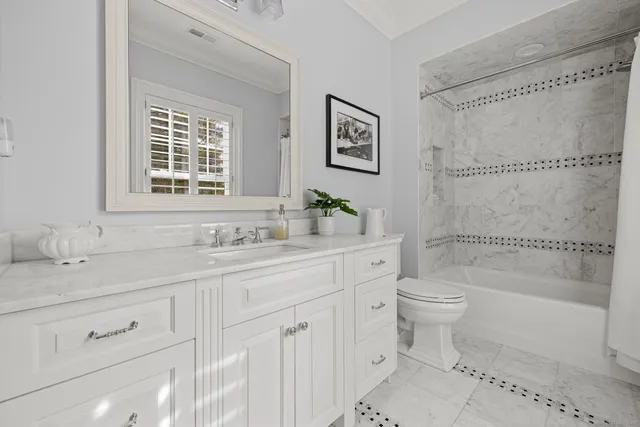 a bathroom with a granite countertop toilet a sink and a bathtub
