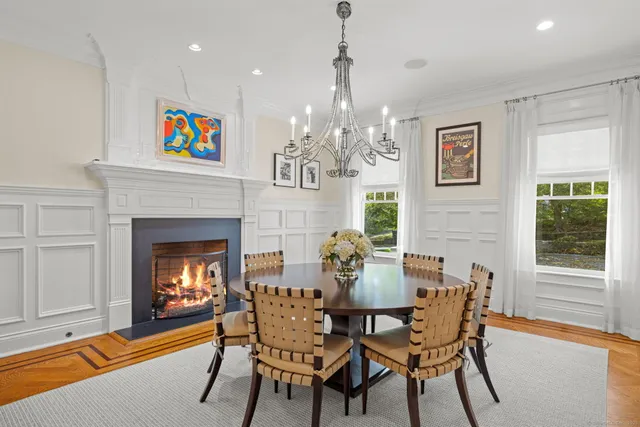 a view of a dining room with furniture and chandelier