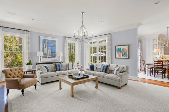 a living room with furniture and a chandelier