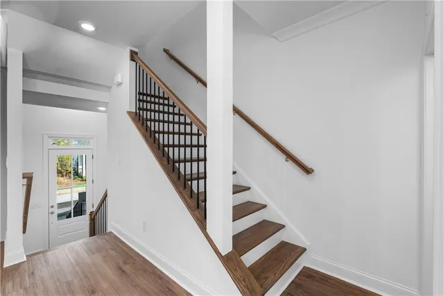 a view of entryway and hall with wooden floor