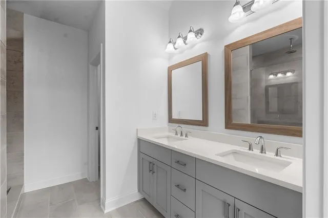 a bathroom with double sink and a mirror