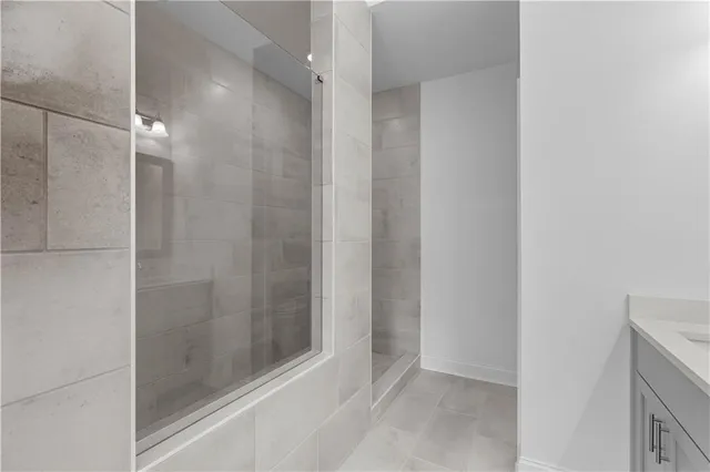 a bathroom with a glass shower door