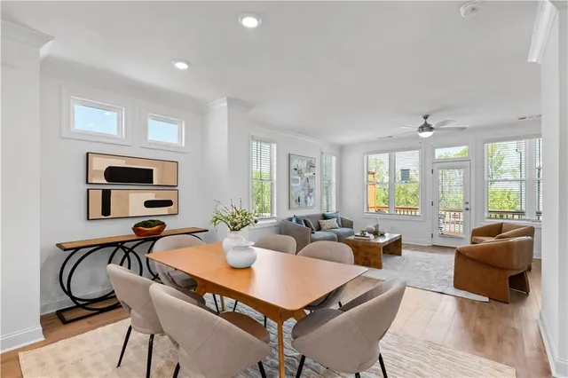 a living room with furniture a flat screen tv and a large window