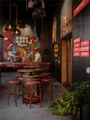 a view of a house with a yard and potted plants