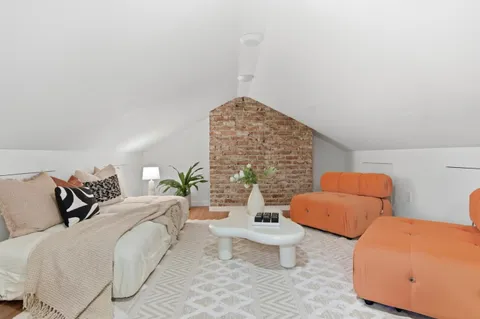 a bedroom with bed and a couch