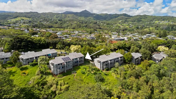 an aerial view of a house with a yard