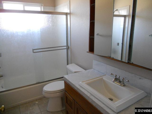 100 John Thomas Lane Reno, NV 89508 - Photo 7 of 13 a bathroom with a sink toilet and shower