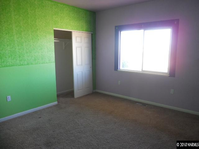 100 John Thomas Lane Reno, NV 89508 - Photo 9 of 13 an empty room with windows and closet