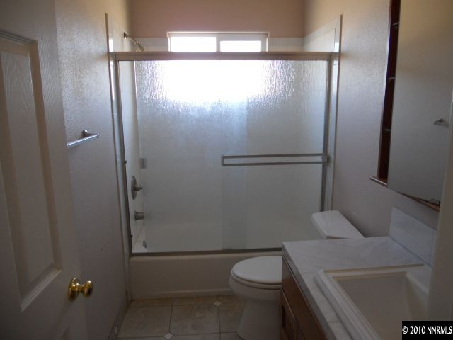 100 John Thomas Lane Reno, NV 89508 - Photo 10 of 13 a bathroom with a granite countertop sink toilet and shower