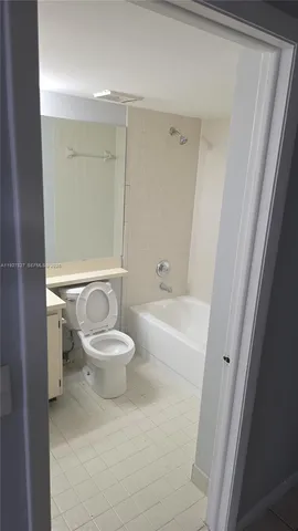 a white toilet sitting next to a bathroom sink