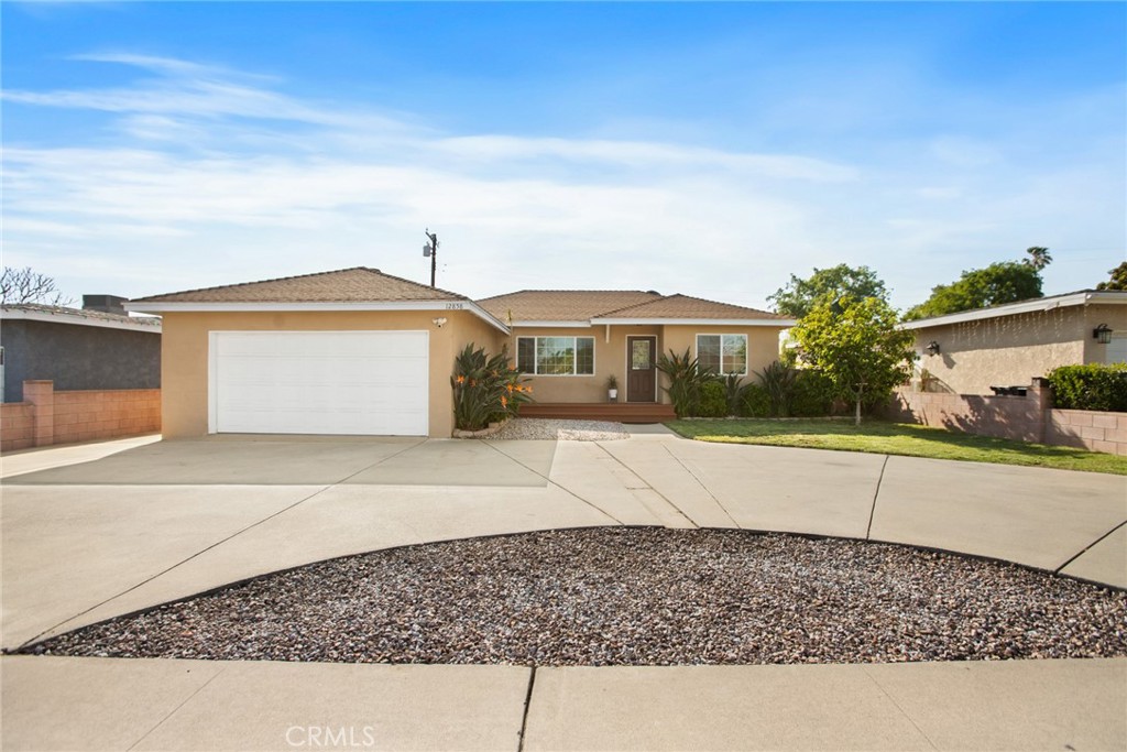 12858 Ramona Avenue Chino, CA 91710 - Photo 1 of 1 a front view of a house with a yard and a garage