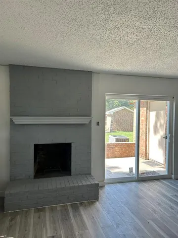 a living room with a fireplace and a large window
