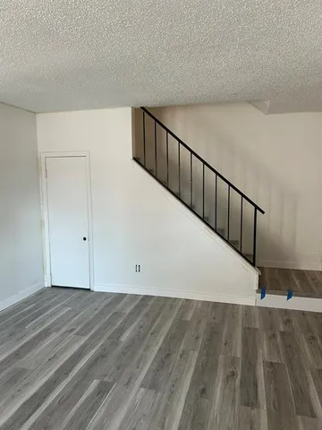 a view of a room with wooden floor