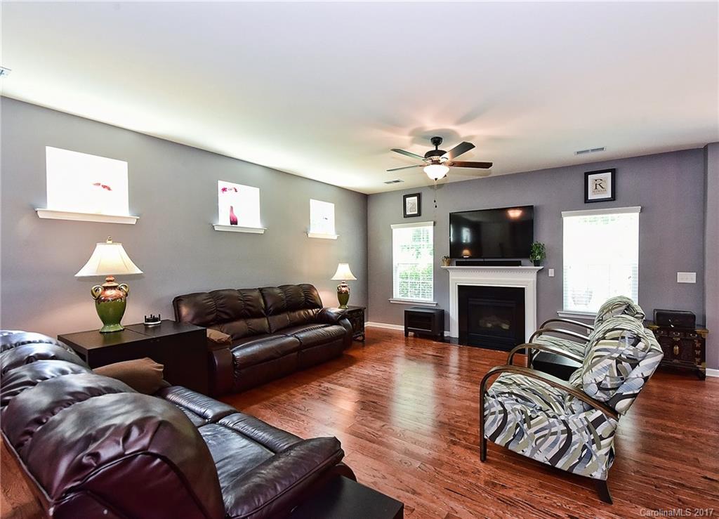 78102 Rillstone Drive Lancaster, SC 29720 - Photo 3 of 22 a living room with furniture a fireplace and a flat screen tv