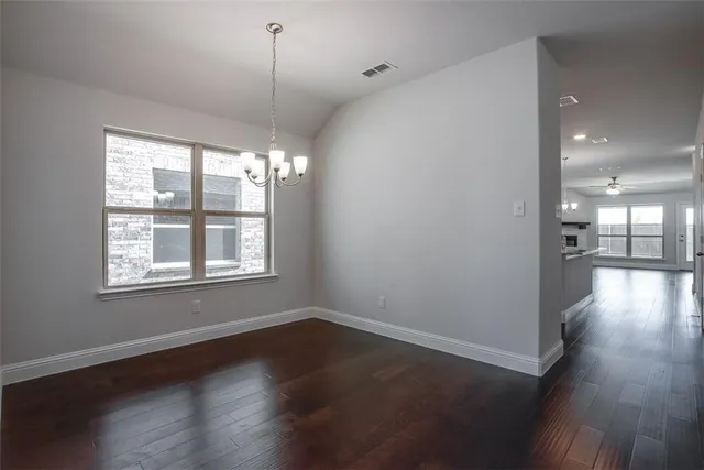 a view of a room window and wooden floor