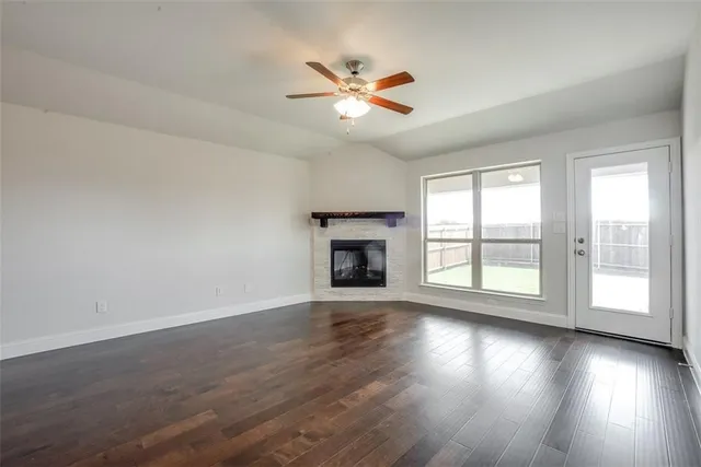 a view of wooden floor and a chandelier fan in a room