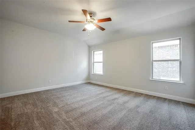 an empty room with closet and windows