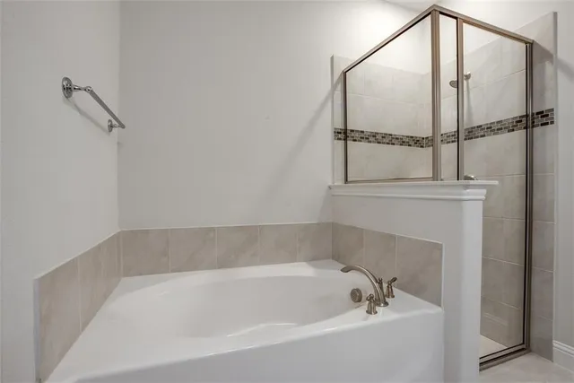 a bathroom with a tub and shower