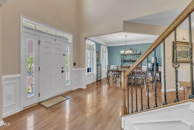 a kitchen with a dining table chairs refrigerator and cabinets