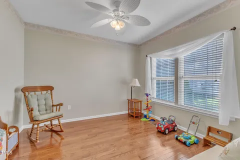 a kitchen with a dining table chairs refrigerator and cabinets